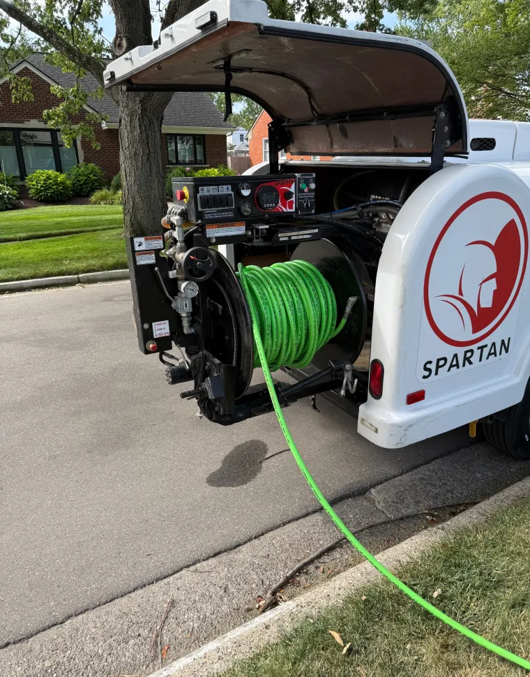 Hydro jetting trailer with hose reel on a residential street