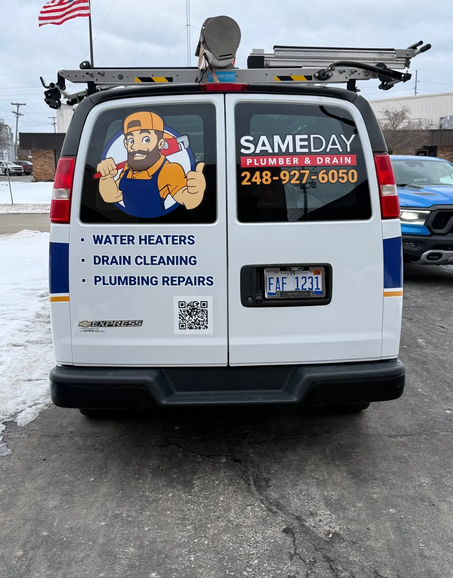 Rear of the service van listing water heaters, drain cleaning and plumbing repairs
