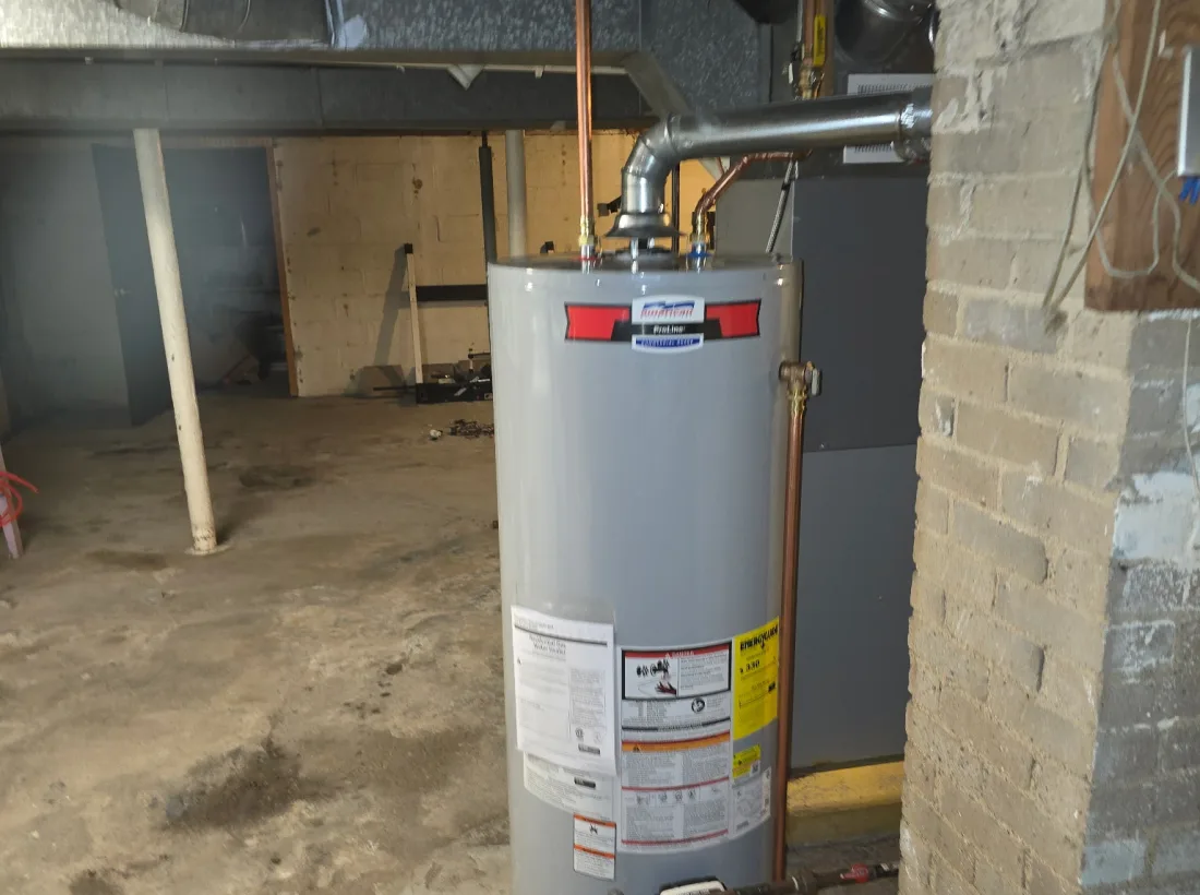 Newly installed gas water heater piped in a Michigan basement